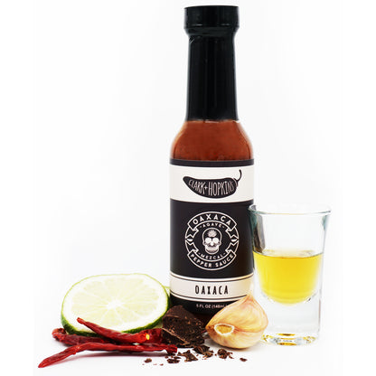 OAXACA front bottle dark chocolate chili peppers garlic clove lime shotglass with mezcal